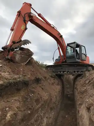 Excavator digging a deep trench