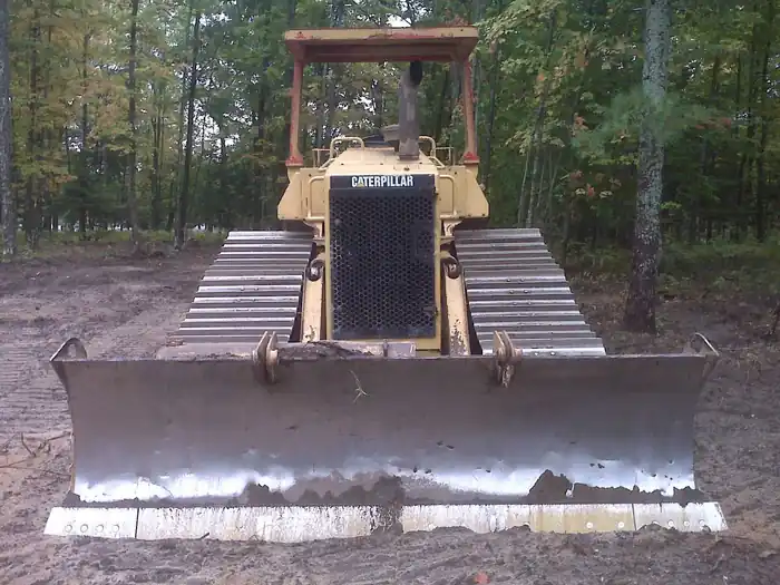 CAT dozer with blade up on freshly cleared ground