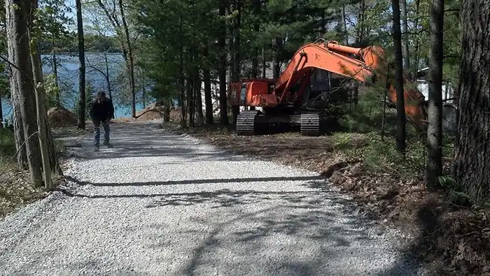 New gravel road running past a lake