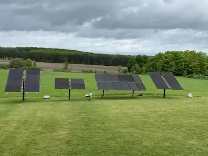 Ground-mount solar array of panels on a residential lawn